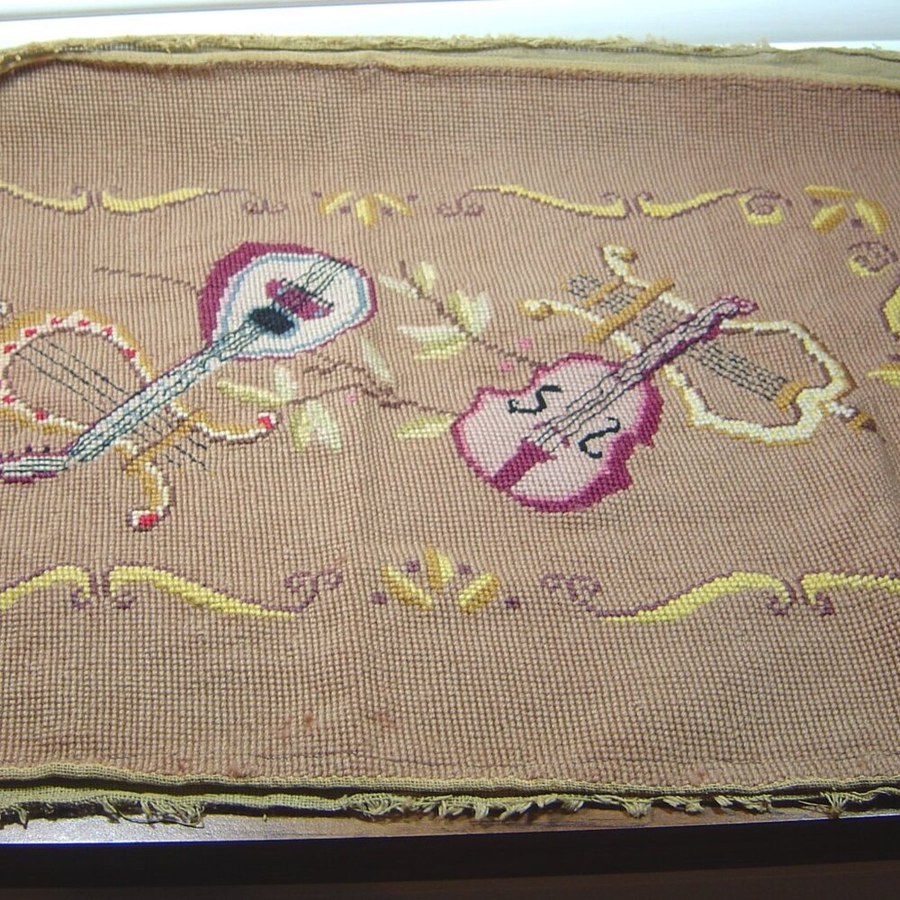 Vintage needlepoint piece with musical instrument theme